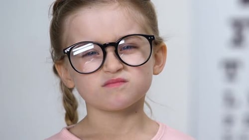 Upset Small Female Kid Taking Off Eyeglasses, Childhood Insecurities, Myopia