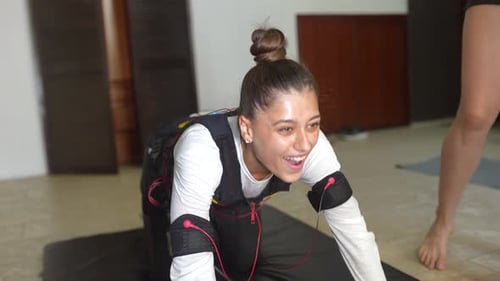 Young Woman Working out Using EMS Technology