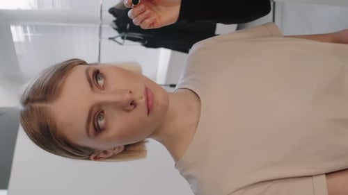 Vertical Shot of Applying Make-Up on Model