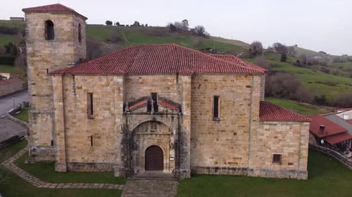 Old church on cloudy day in green valley
