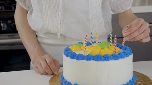 Birthday Cake Preparation With Colorful Candles at Home
