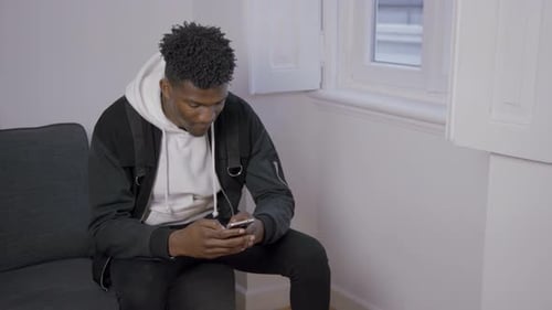 Portrait of Concentrated African American Man Texting Message