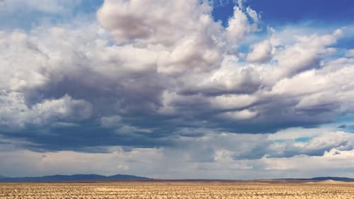 Hyperlapse of dark storm clouds gathering over Mojave Desert landscape