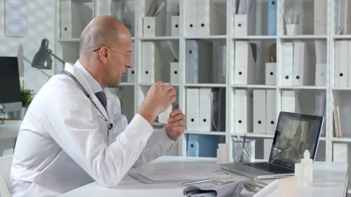 Doctor Doing Remote Consultation With Patient on Laptop