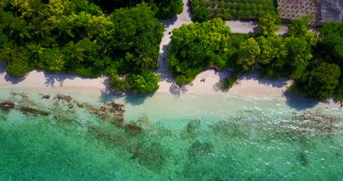 Natural above tourism shot of a white sandy paradise beach and aqua blue water background in hi res