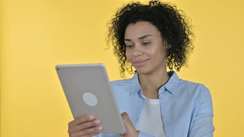 Young Woman Scrolls on Tablet Device