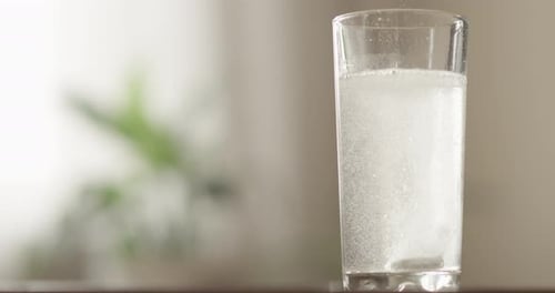 Effervescent Tablet Dissolving in a Glass of Water