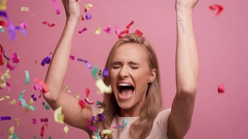 Excited Woman Celebrates Under Confetti Shower