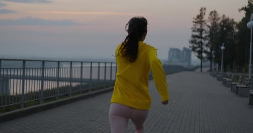 Young Woman Running In The Park