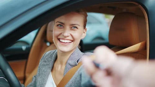 Happy Woman Receives Car Keys, Smiling In Car