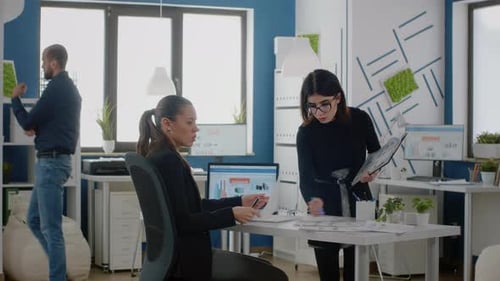 Women Reviewing Data in Modern Office Setting