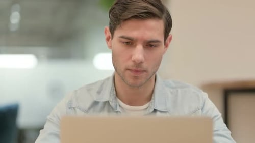 Close Up of Creative Young Man Working on Laptop