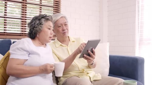 Senior Couple Relaxing at Home with Tablet