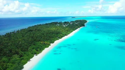 Daytime birds eye abstract shot of a sandy white paradise beach and aqua turquoise water background