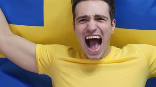 Excited Man Cheering in front of Flag