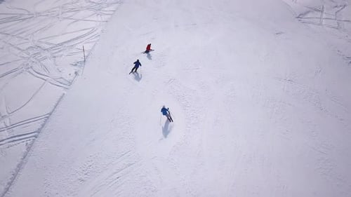 People skiing and snowboarding on snow slope in winter ski resort. Ski elevator on snow mountain. Wi