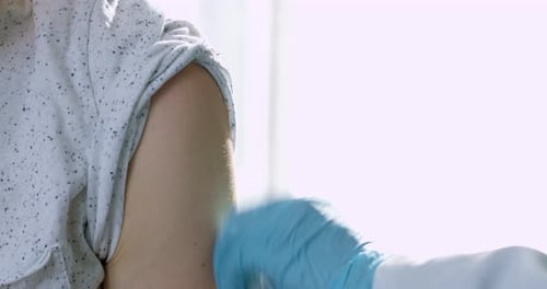 Health Professional Administering Injection to Patient's Shoulder