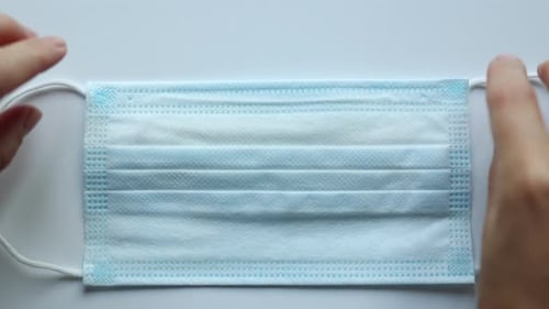 Covid Mask Next to Scrabble Letters Spelling Breathe