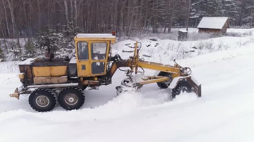 Aerial view of Snowblower Grader Clears Snow Covered Country Road next to the forest 15