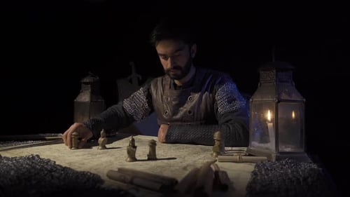 Bearded Man Contemplates Strategy by Candlelight
