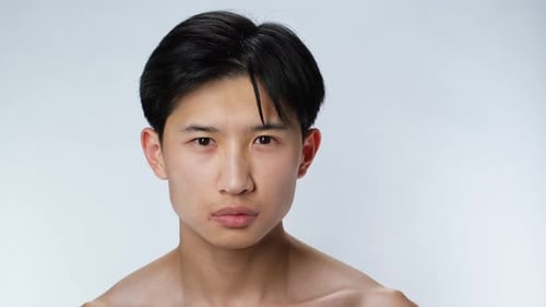 Asian Face Sweet Person Looking at Camera Confusion Closeup White Background .