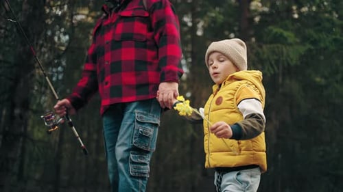Adult and Child Walking in a Forest