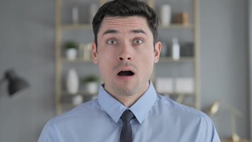Man Reacts in Shock and Disbelief