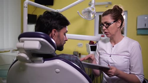 Doctor Explains Diagnosis to Patient Using Tablet