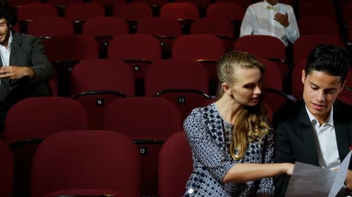 Theater Audience Reads Program Before Performance