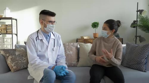 Doctor Consulting with Patient at Home