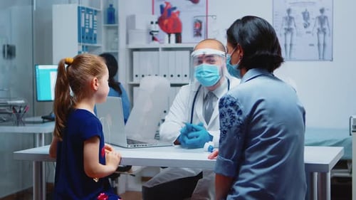 Doctor Consults With Child in Office Setting