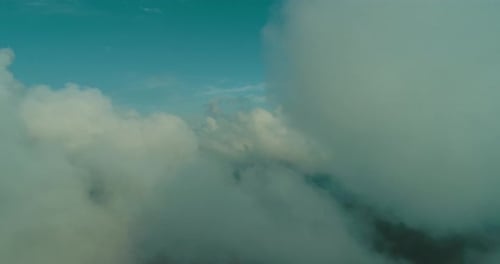 Aerial Fly Above Clouds with Blue Sky in Backgroubnd on Beautiful Sunny Day