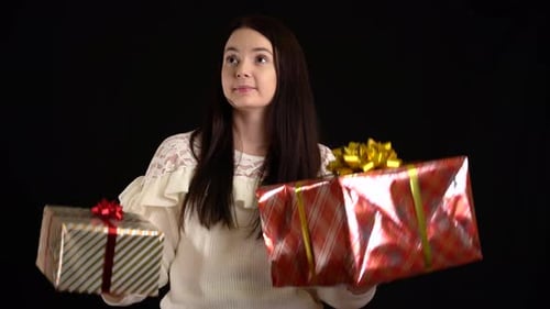 Woman Choosing Between Beautiful Gift Boxes