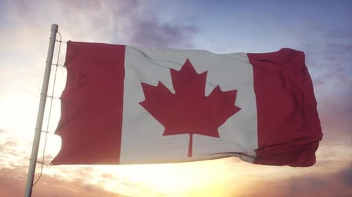 Canadian Flag Waving Against Beautiful Sunset Sky