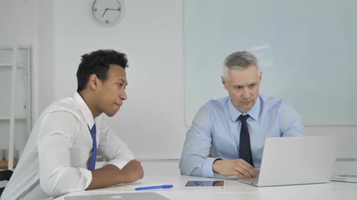 Men Discuss Business in Bright Modern Office