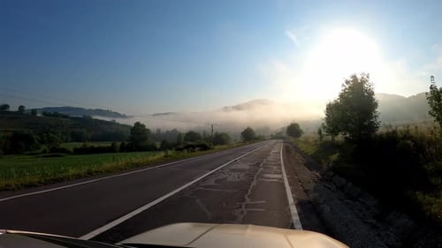 POV shot of driving a car on the road along the forest and mountains. Traveling in the summer by car