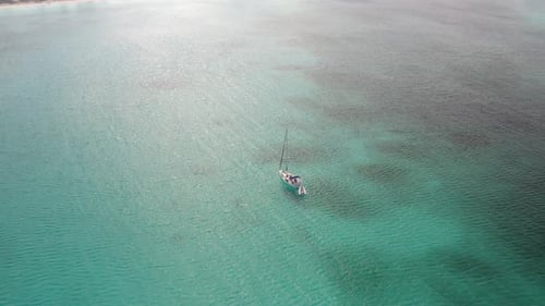 View Of An Isolated Yacht Cruising On Pristine Water In The Islands Of Bahamas, Florida. - Aerial Sh