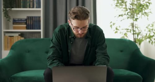 Programmer with Laptop at Home