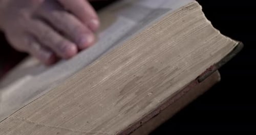 Hand Flips Pages of Weathered Antique Book