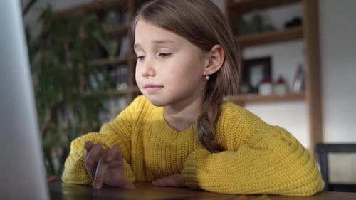 Girl Using Laptop Computer at Desk Indoors