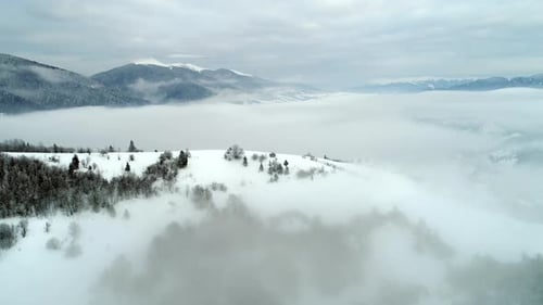 Aerial View in Foggy Sunset Winter Mountain