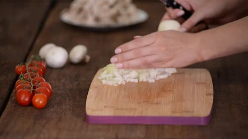 Woman Dicing White Onion for Cooking at Home