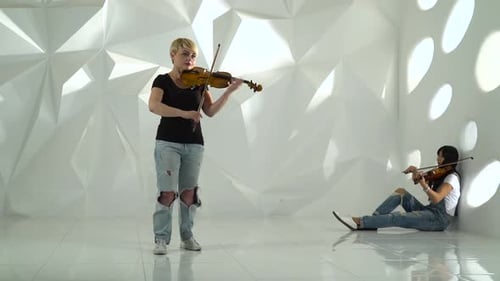 Women Play Violins in Modern White Room