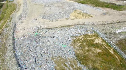 The huge garbage dump on the outskirts of the forest, view from drone