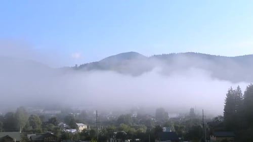 Fog Over Mountainous Green Landscape on a Sunny Day