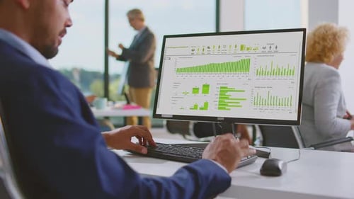 Man analysing data and charts on monitor
