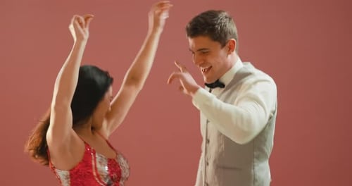 Cheerful Couple Dancing as Confetti Falls