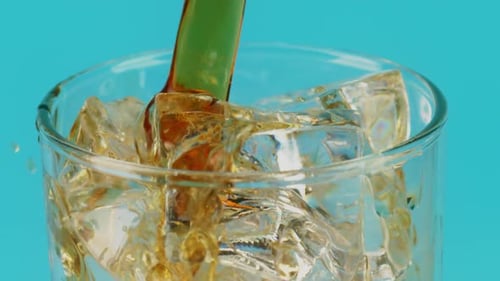 Dark Liquid Poured Over Ice in Glass