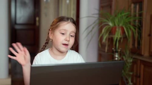 Girl Using Laptop for Online Communication at Home