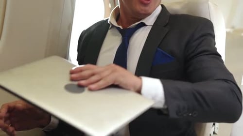 Man Preparing for Airplane Nap Wearing Eye Mask